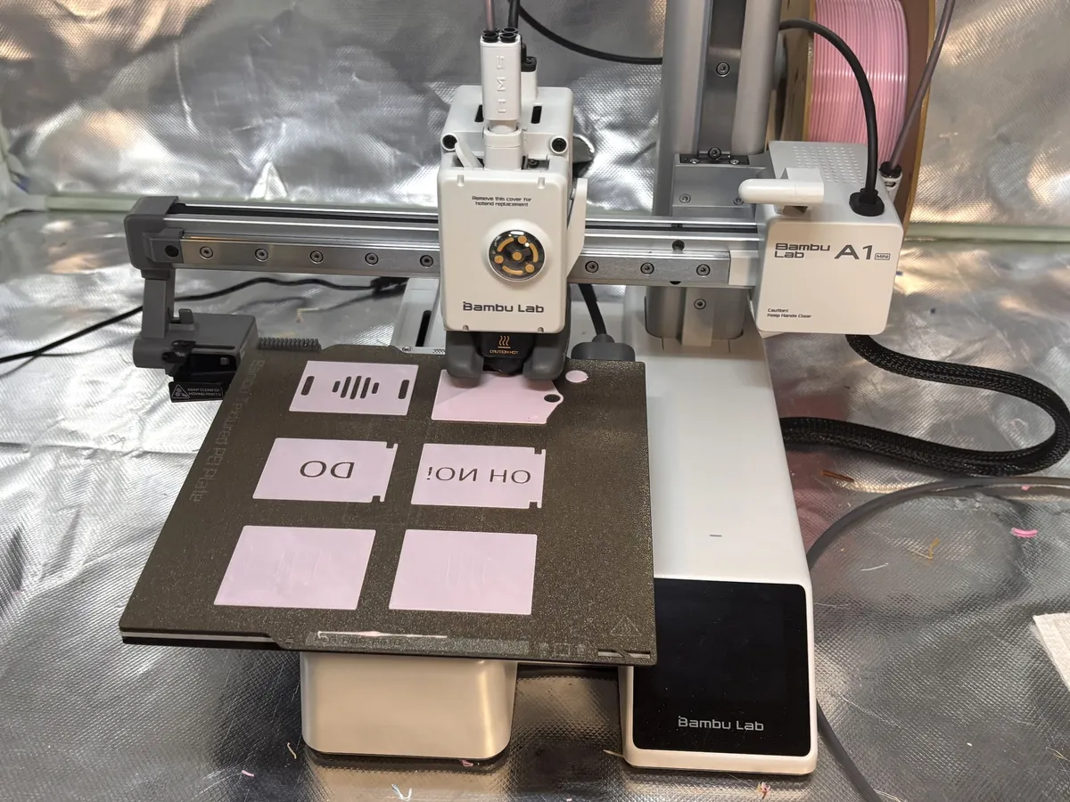 A 3D printer partway through printing a plate of DoDone parts